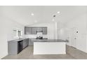 Bright kitchen featuring gray cabinets, granite countertops, and stainless steel appliances at 2664 Hancock Crossing Dr, Bartow, FL 33830