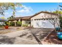 Attractive single-Gathering home with a two-car garage and a well-maintained driveway and landscaping at 2717 Rose Moss Ln, Orlando, FL 32807