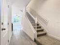 Bright and airy entryway with staircase, tile flooring, and access to other rooms at 3196 Crown Jewel Ct, Winter Park, FL 32792