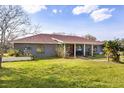 Charming single-story home featuring a cozy front porch and well-maintained lawn at 36129 E Eldorado Lake Dr, Eustis, FL 32736