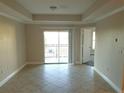 Bright and spacious living room with tile floors and access to a balcony at 3700 Castle Pines Ln # 4032, Orlando, FL 32839