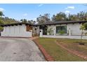 White stucco home with a modern design, black accents, and nicely landscaped front yard at 409 San Sebastian Prado, Altamonte Springs, FL 32714