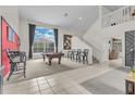 Game room with a pool table, comfortable seating, and a high ceiling at 4549 Saddleworth Cir, Orlando, FL 32826