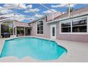 Inviting swimming pool with a screened enclosure and patio furniture at 4549 Saddleworth Cir, Orlando, FL 32826