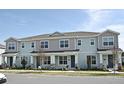 Three attached townhouses featuring light blue siding and gray accents at 627 Bayhawk St, Debary, FL 32713