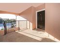 Apartment entry with private balcony and view of trees at 6413 Astor Village Ave # 305, Orlando, FL 32835