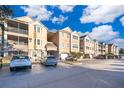 Exterior view of apartment building with parking spaces at 6413 Astor Village Ave # 305, Orlando, FL 32835