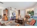 Spacious living room featuring a wood cabinet and TV at 680 Avenue N Se, Winter Haven, FL 33880