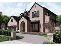 Brick home with herringbone driveway, landscaping, and a two-car garage at 702 Via Bella, Winter Park, FL 32789