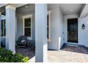 Inviting front porch with a comfortable seating area and a view of the street at 8547 Bayview Crossing Dr, Winter Garden, FL 34787