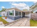 Gray and white ranch home with a carport and well-maintained landscaping at 1012 N Ferncreek Ave, Orlando, FL 32803