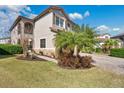 Two-story house with palm trees and a brick driveway at 10389 Henbury St, Orlando, FL 32832