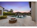 Relaxing pool and patio area with fire pit, perfect for outdoor entertaining at 10443 Los Feliz Dr, Orlando, FL 32836