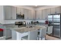 Modern kitchen featuring gray cabinets, granite countertops, and stainless steel appliances at 1331 Foran Manor Rd, Haines City, FL 33844