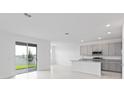Open-concept kitchen and dining area with sliding glass doors leading to the backyard at 1343 Foran Manor Rd, Haines City, FL 33844