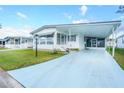 Front view of a white mobile home with carport at 1401 W Highway 50 # 68, Clermont, FL 34711