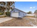 View of the side of the house, showing garage and landscaping at 148 Imperial Oak Ct, Davenport, FL 33896