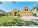 Two-story house with a large yard, two-car garage, and attractive facade at 1580 Prairie Oaks Dr, St Cloud, FL 34771