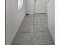 Simple hallway featuring tile flooring and neutral colors at 1603 Gardiner St, Haines City, FL 33844