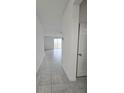 Bright hallway with tile flooring leading to living area at 1603 Gardiner St, Haines City, FL 33844