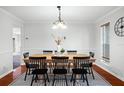 Dining room featuring a wood table, black chairs, and a chandelier at 1718 Errol Woods Dr, Apopka, FL 32712