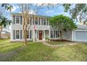 Two-story house with gray siding, landscaping, and a walkway at 1718 Errol Woods Dr, Apopka, FL 32712