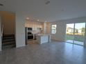 Kitchen with island, stainless steel appliances, and grey tile floors at 2499 Skyline Loop, Kissimmee, FL 34758