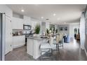 Modern kitchen with white cabinets, granite countertops, and stainless steel appliances at 3582 Fort Mellon Ln, Sanford, FL 32773