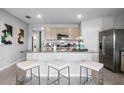 Kitchen island with seating for three, granite counters at 3818 Royal Azalea Way, Sanford, FL 32773