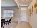 Bright and airy entryway with tile flooring and a view into a home office at 3834 Royal Azalea Way, Sanford, FL 32773