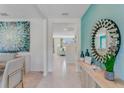 Bright and airy foyer with wood-look console table and large mirror at 3842 Royal Azalea Way, Sanford, FL 32773