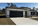 New construction home with gray garage door and stone accents at 3901 Sw 161St Loop, Ocala, FL 34473