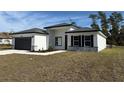 New construction home with gray garage door and stone accents at 3901 Sw 161St Loop, Ocala, FL 34473