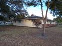 Side view of ranch home showcasing brick and siding at 4131 Yorketowne Rd, Orlando, FL 32812