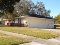 Ranch house with attached garage and red shutters at 4131 Yorketowne Rd, Orlando, FL 32812