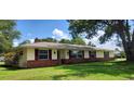 This single-story home has an attractive brick and siding exterior and a neatly manicured lawn at 4131 Yorketowne Rd, Orlando, FL 32812