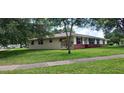 A single-story home with a brick facade and a well-maintained lawn are the exterior highlights at 4131 Yorketowne Rd, Orlando, FL 32812