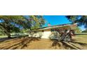 Exterior view of a single-story home showcasing the backyard and the surrounding landscaping at 4131 Yorketowne Rd, Orlando, FL 32812