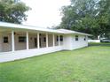 A screened-in patio featuring ceiling fans, offering an ideal space for outdoor relaxation and entertaining at 4131 Yorketowne Rd, Orlando, FL 32812