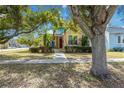 House exterior with mature trees and well-maintained lawn at 436 E Jersey St, Orlando, FL 32806