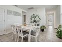 Bright dining room with white table and gray chairs at 4451 Rapallo Ave, Winter Haven, FL 33884