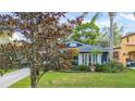 Blue house with white shutters, mature trees, and well-maintained lawn at 512 E Gore St, Orlando, FL 32806