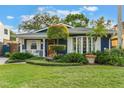 Cute bungalow with manicured lawn, beautiful landscaping, and a charming facade at 512 E Gore St, Orlando, FL 32806