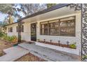 Welcoming front porch with brick planter and black wrought iron accents at 520 Sw 38Th St, Ocala, FL 34471