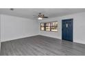 Spacious living room featuring gray laminate flooring and a ceiling fan at 520 Sw 38Th St, Ocala, FL 34471