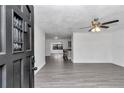 Open-concept living room with wood-look floors that connects to the kitchen and dining area at 520 Sw 38Th St, Ocala, FL 34471