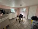 Small kitchen with white cabinets and tiled floor, ready for updates at 641 W Beresford Rd, Deland, FL 32720