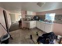 Simple kitchen with white cabinets and tiled floor at 641 W Beresford Rd, Deland, FL 32720