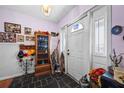 Entryway with tile flooring, storage cabinet, and coat rack at 6517 Precourt Dr, Orlando, FL 32809