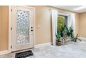 Bright entryway with a stained glass door and potted plants at 8045 Happy Trl, Kissimmee, FL 34747